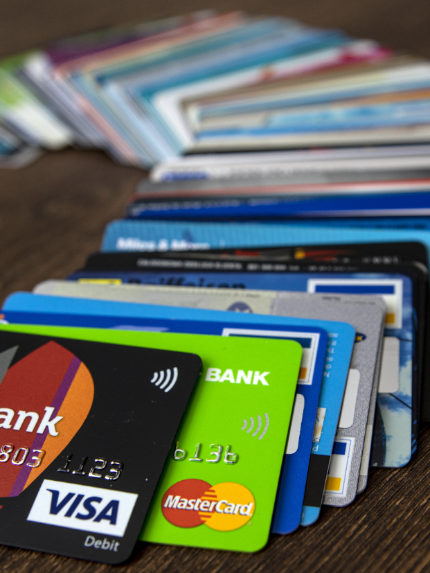 A stack of credit cards on a desk, depicting payment processing