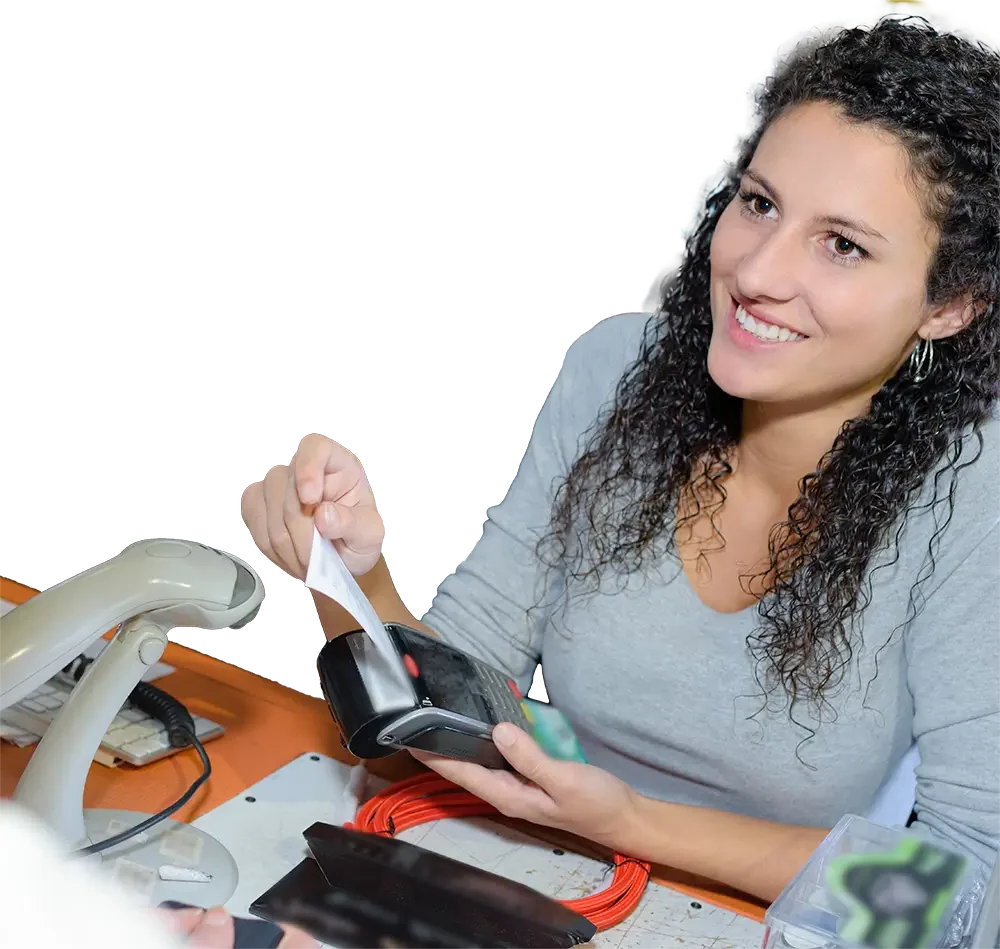 Curly haired cashier holding a merchant credit card processing reader with a receipt coming out of it