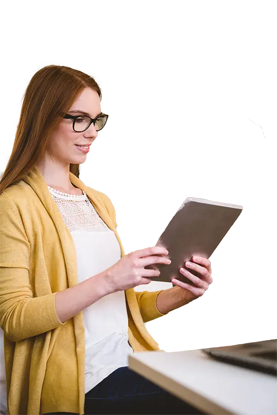 Woman looking at a tablet sitting at a desk, depicting payment processing